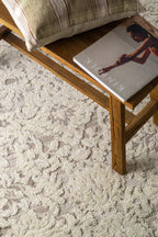 Cream and taupe traditional floral patterned area rug with ornate border