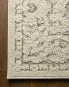 Cream and taupe traditional floral patterned area rug with ornate border