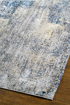 Modern distressed area rug with blue and grey abstract pattern on cream background