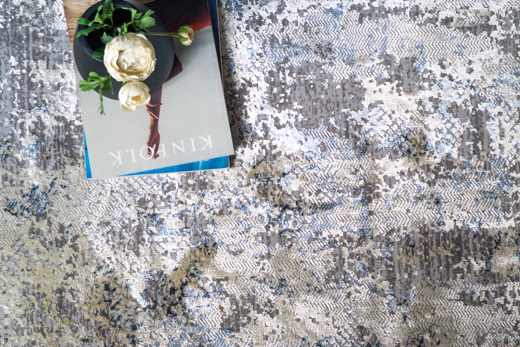 Modern distressed area rug with blue and grey abstract pattern on cream background