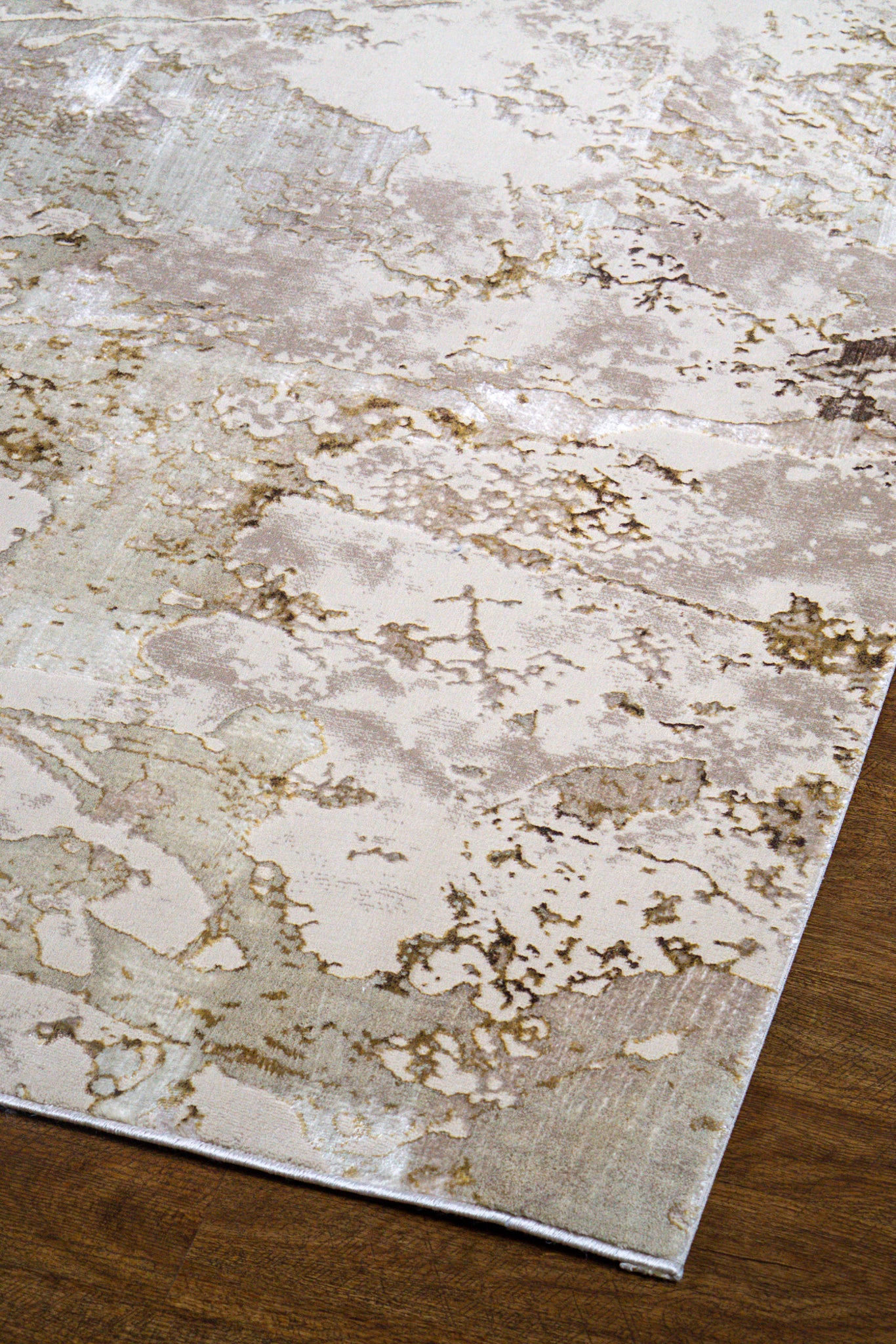 Distressed beige and gold textured area rug with vintage worn finish