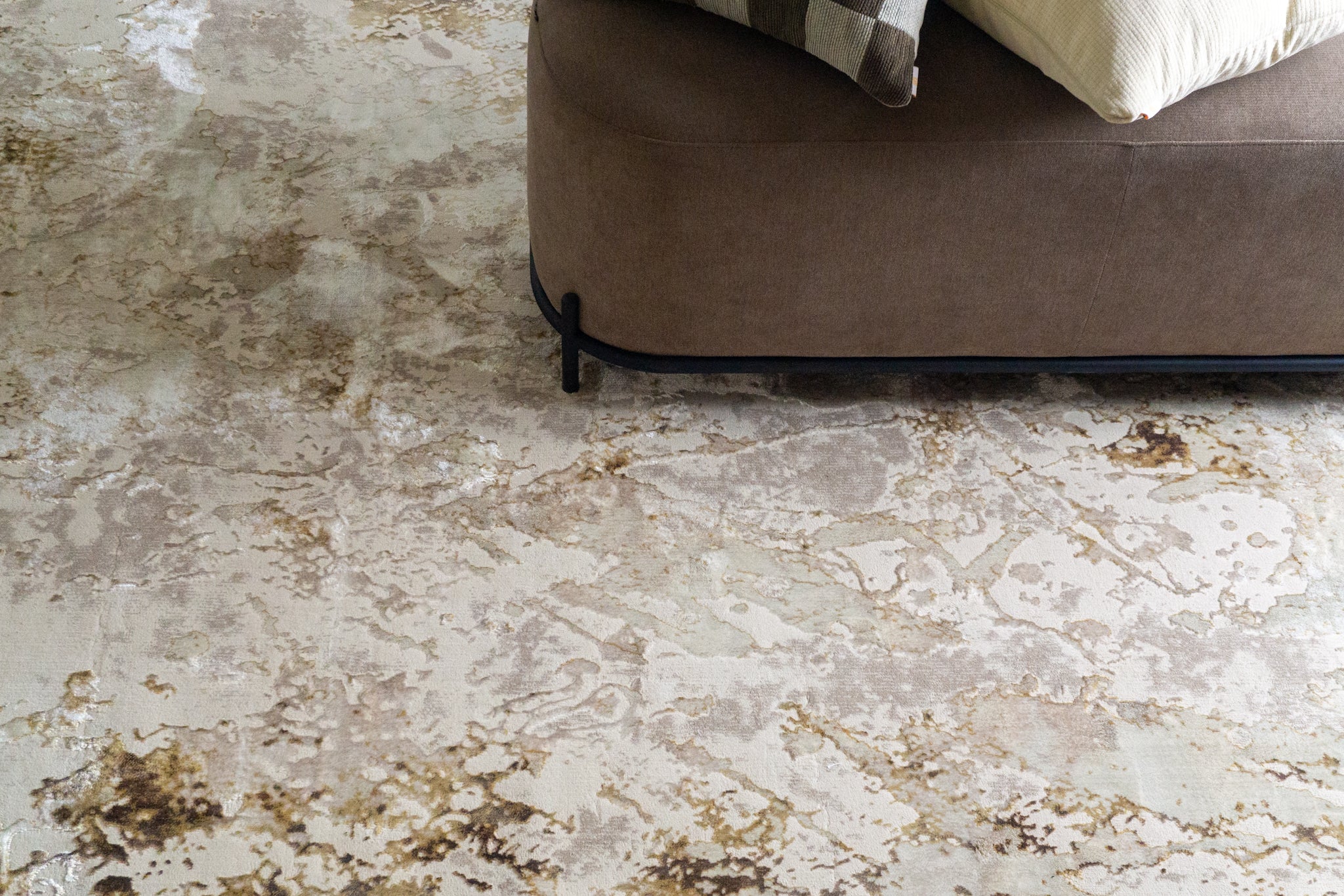 Distressed beige and gold textured area rug with vintage worn finish