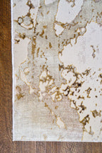 Distressed beige and gold textured area rug with vintage worn finish