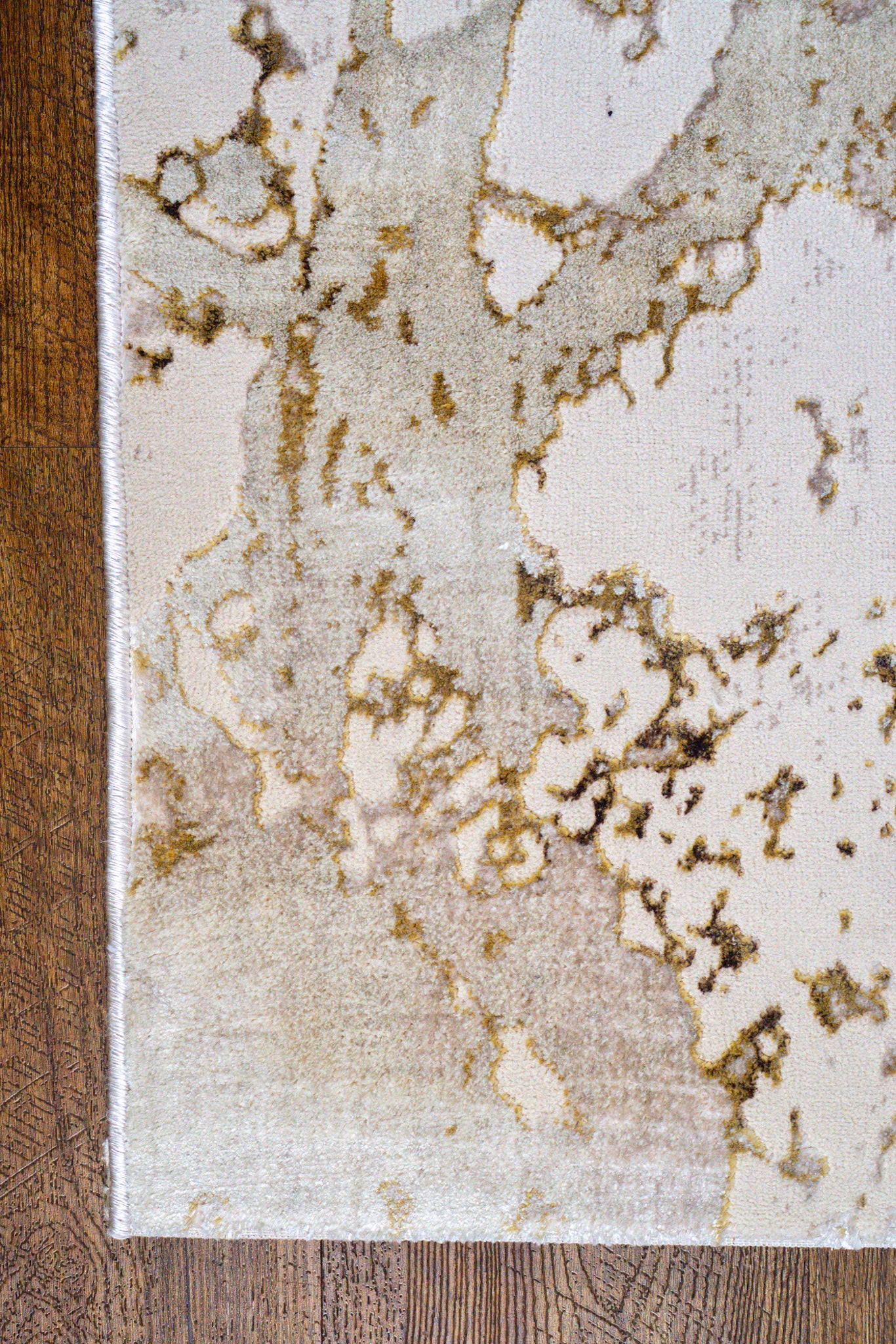 Distressed beige and gold textured area rug with vintage worn finish
