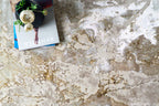 Distressed beige and gold textured area rug with vintage worn finish