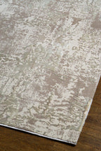 Distressed beige and taupe abstract rug with weathered texture design