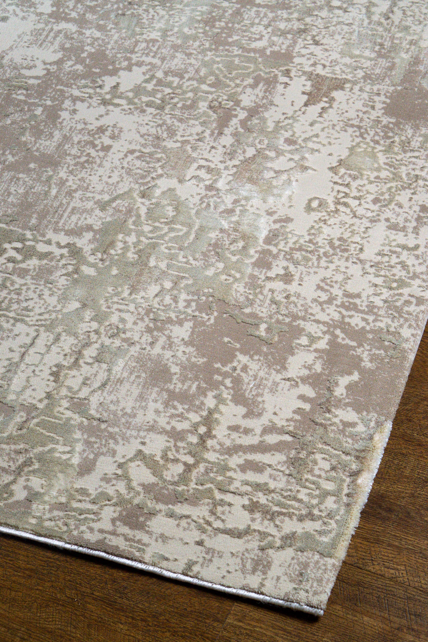 Distressed beige and taupe abstract rug with weathered texture design