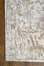 Distressed beige and taupe abstract rug with weathered texture design