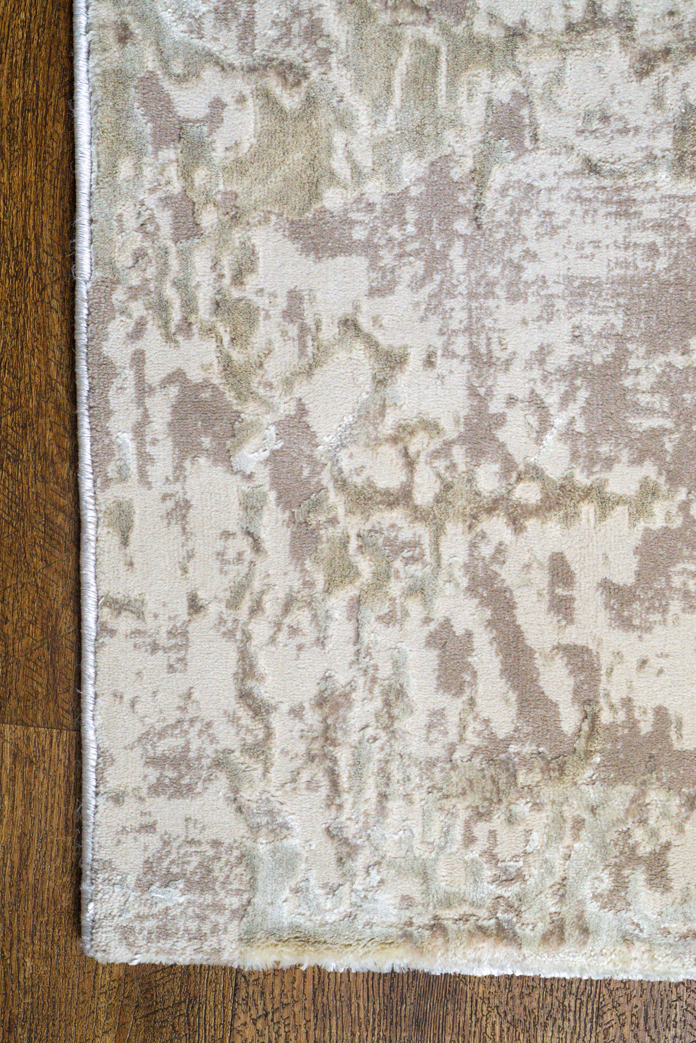 Distressed beige and taupe abstract rug with weathered texture design