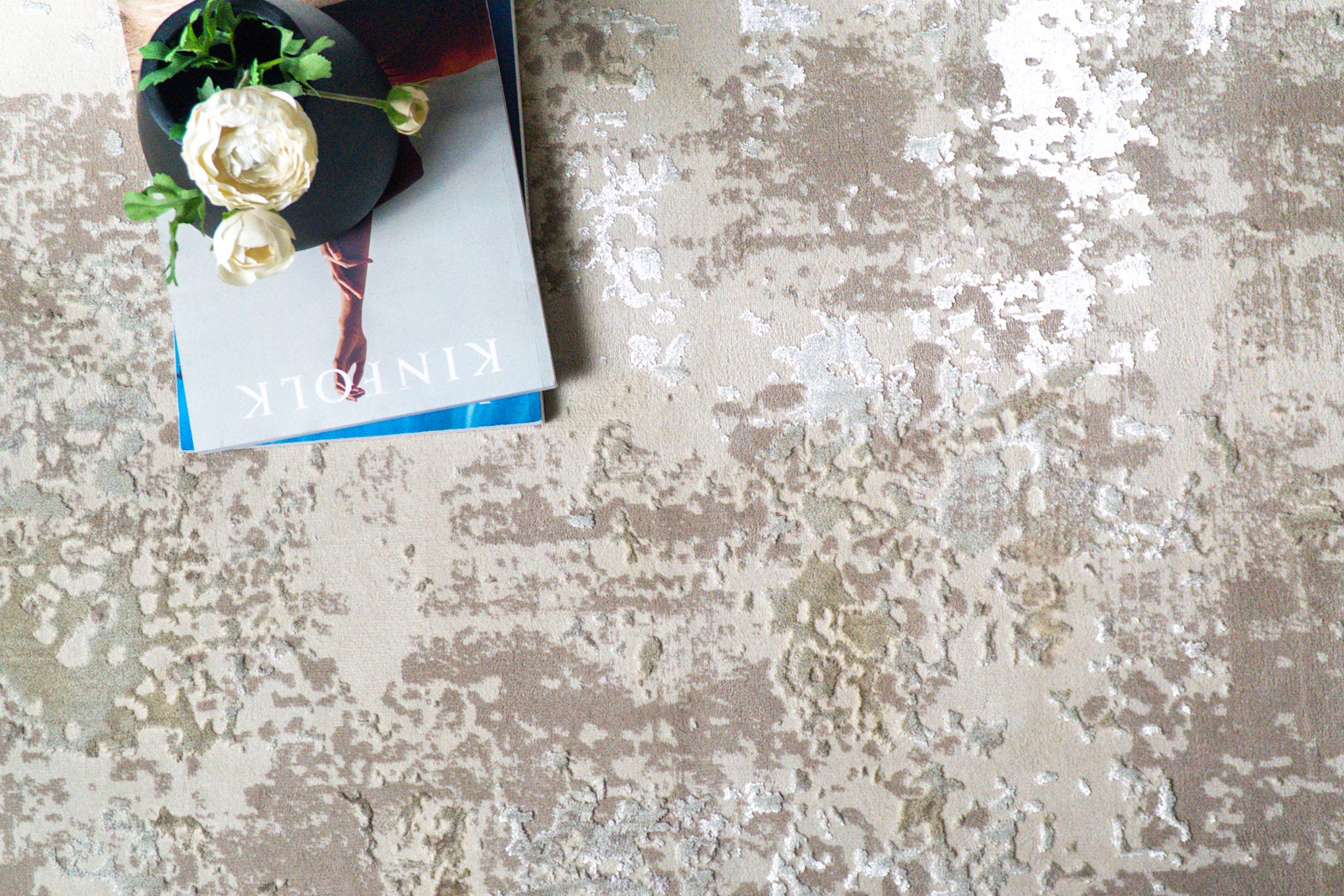 Distressed beige and taupe abstract rug with weathered texture design