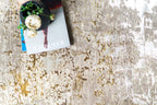 Distressed beige and gold abstract textured rug with worn vintage aesthetic
