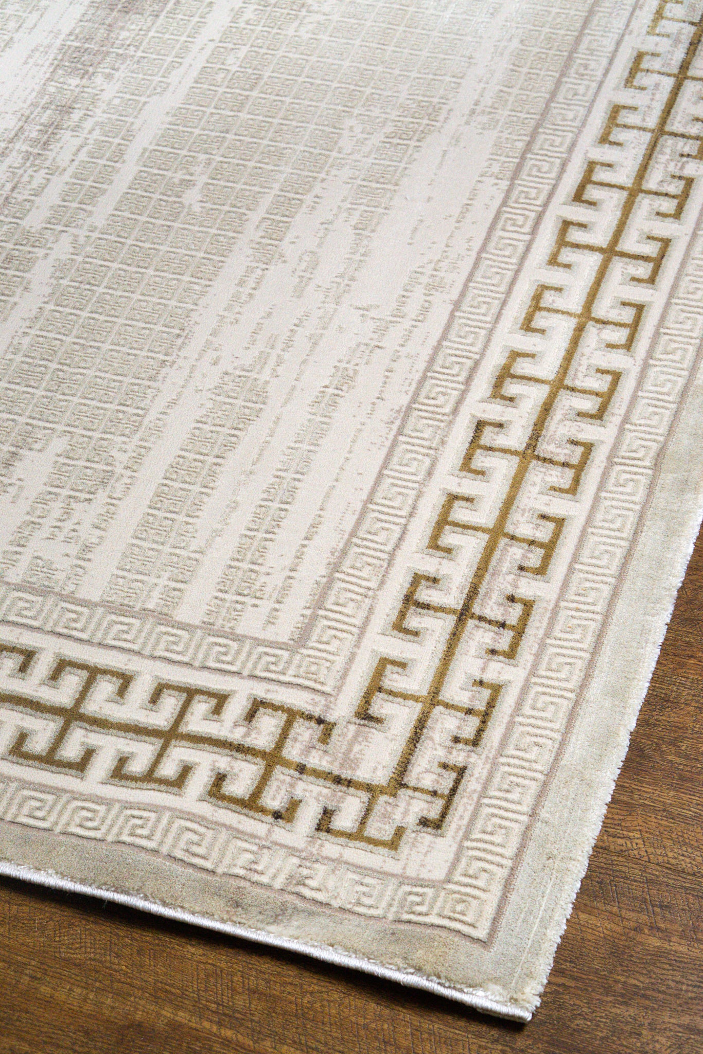 Cream and gold geometric Greek key patterned rug with textured distressed finish