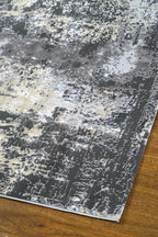 Modern distressed area rug in grey and cream tones with abstract pattern