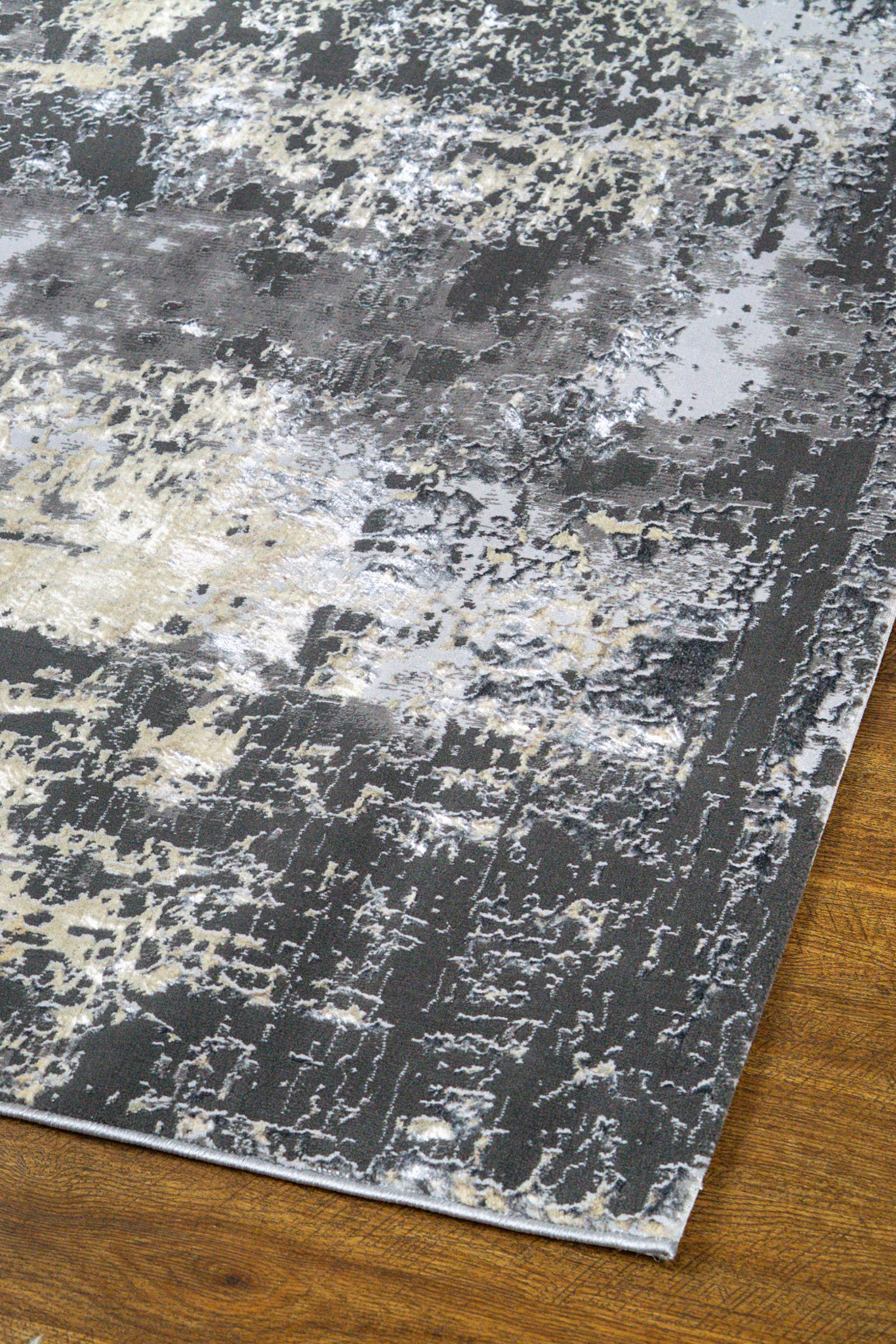 Modern distressed area rug in grey and cream tones with abstract pattern