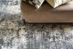 Modern distressed area rug in grey and cream tones with abstract pattern