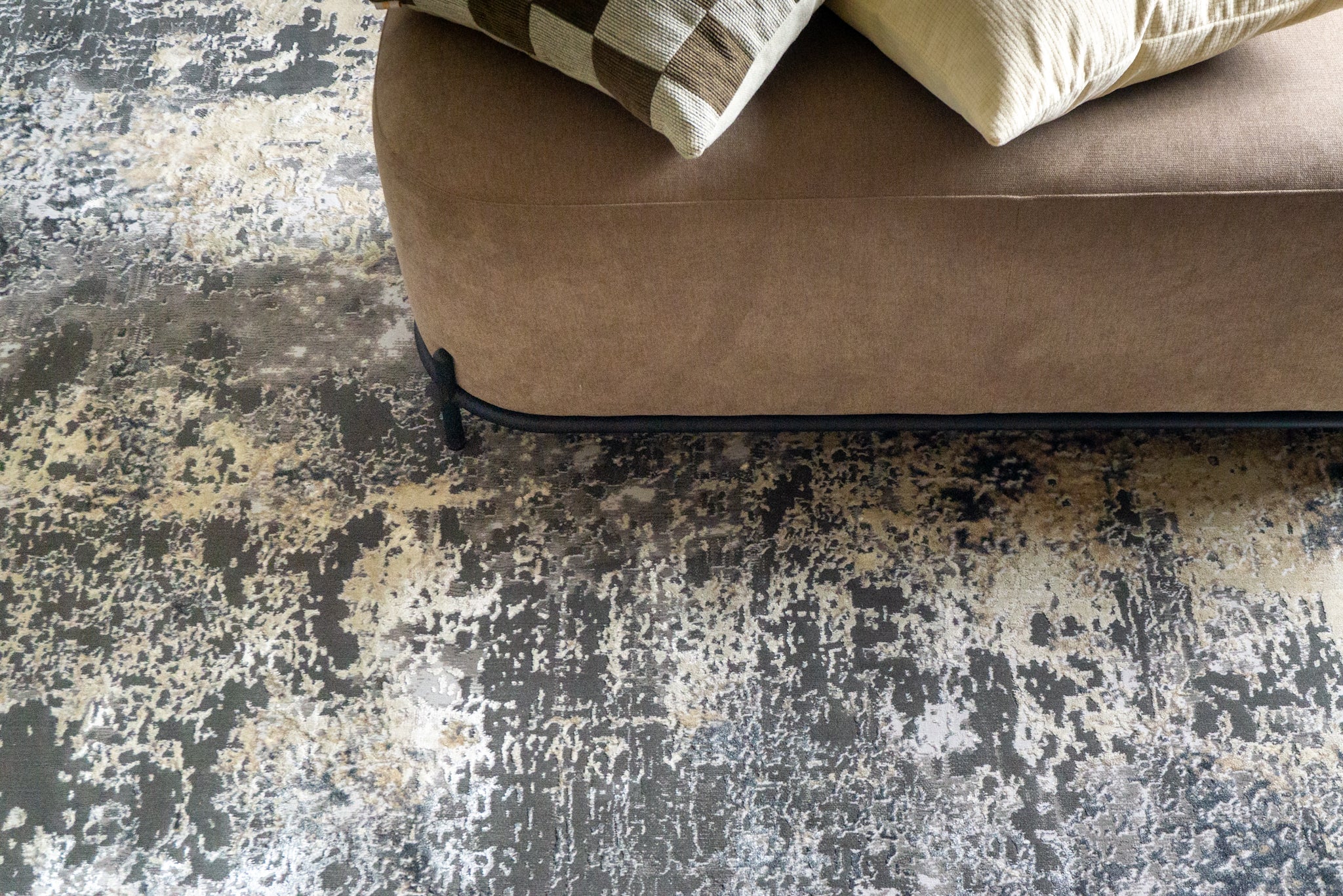Modern distressed area rug in grey and cream tones with abstract pattern