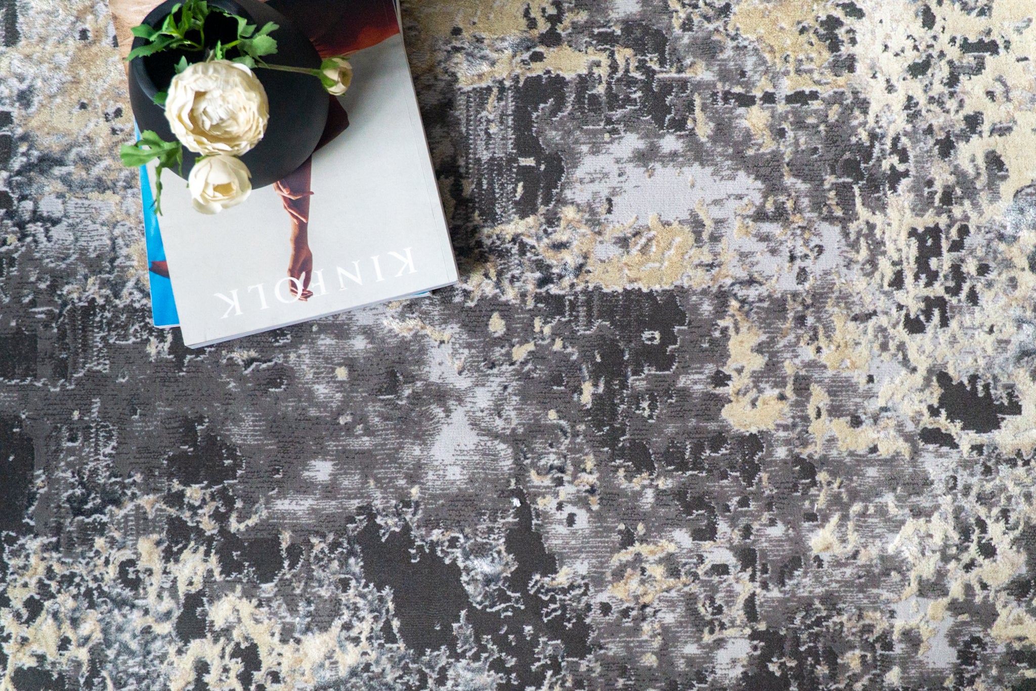 Modern distressed area rug in grey and cream tones with abstract pattern