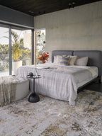 Abstract distressed rug with gold, grey, and cream weathered texture pattern