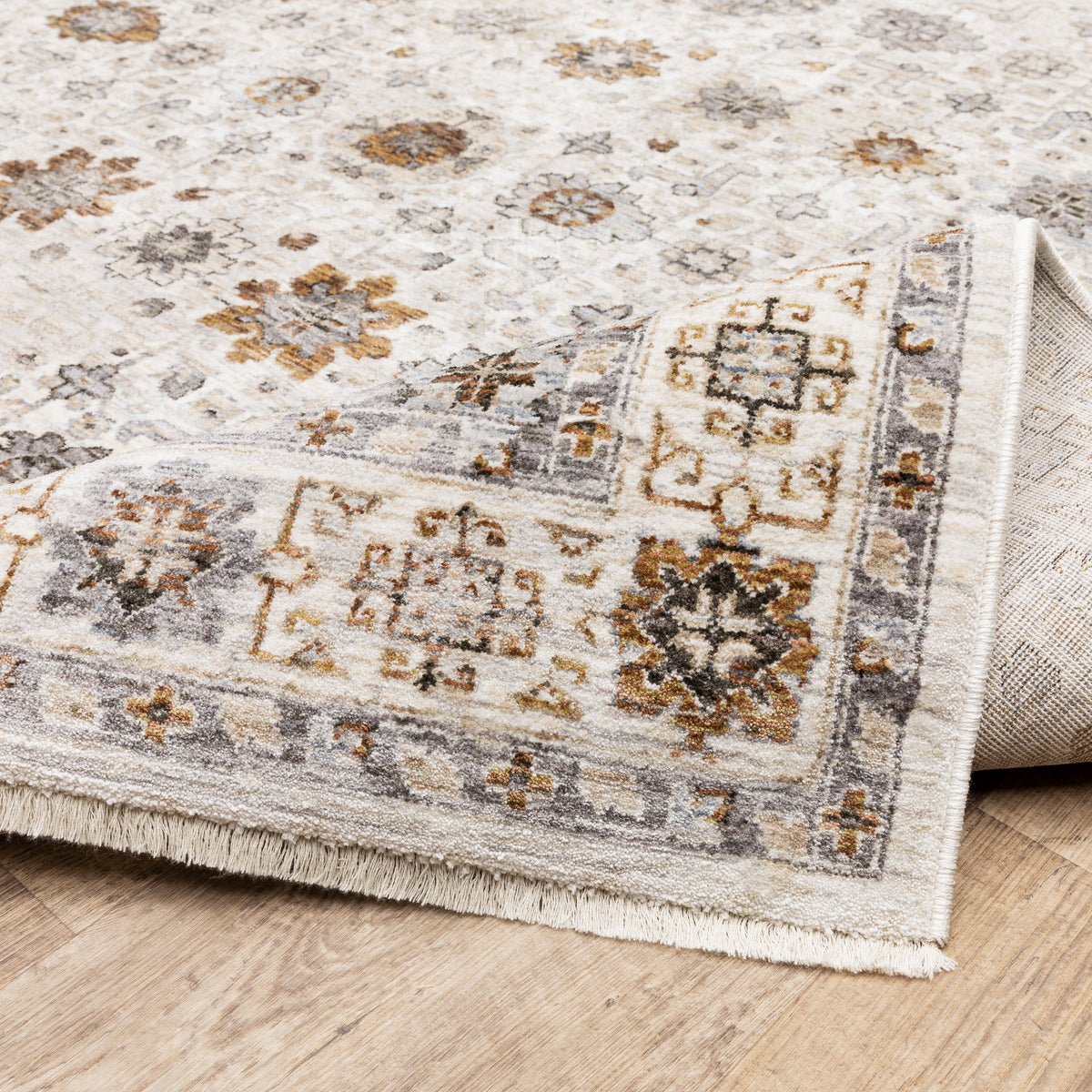 Beige traditional rug with brown and grey floral medallion pattern and ornate border