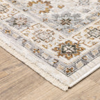 Beige traditional rug with brown and grey floral medallion pattern and ornate border