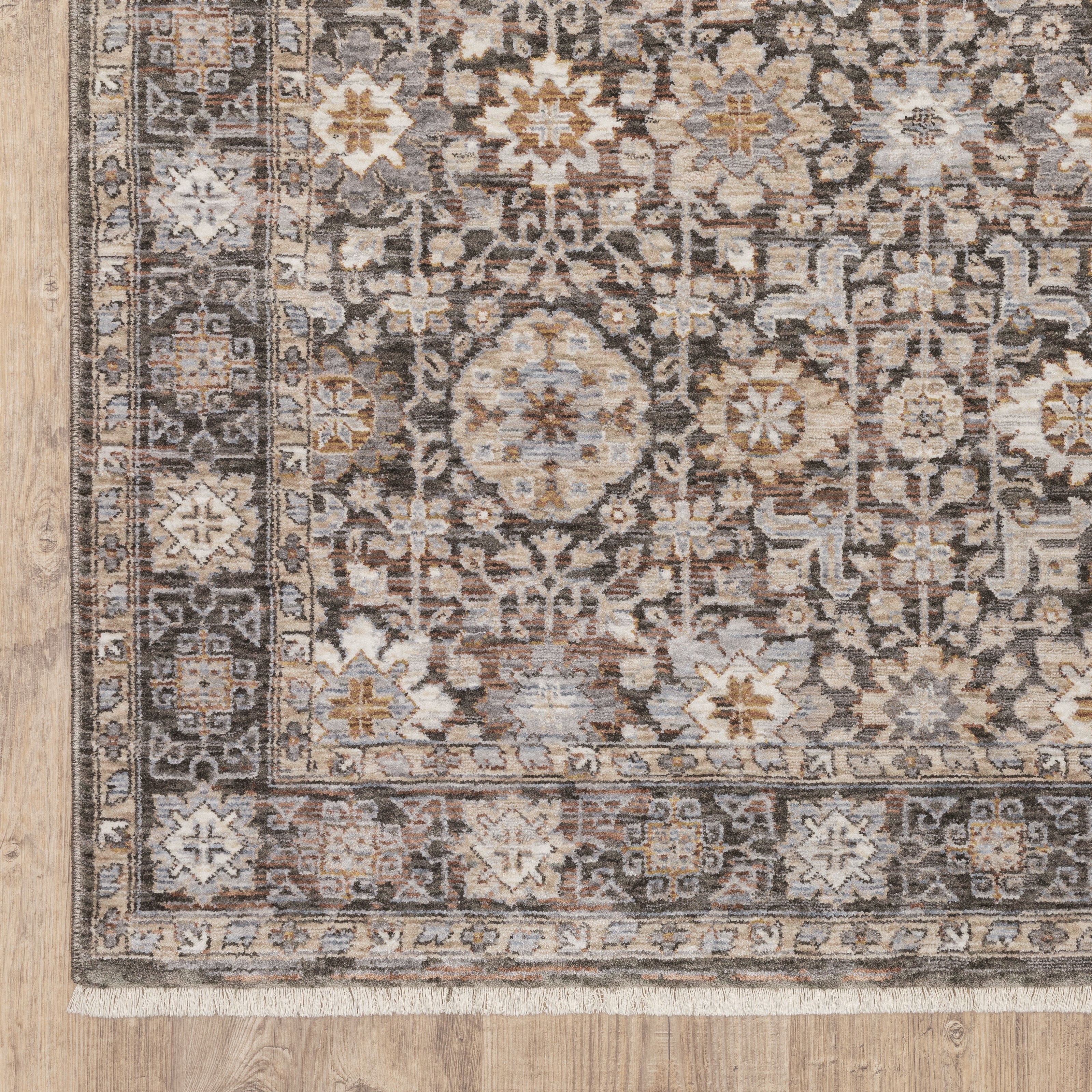 Vintage-style area rug with intricate geometric patterns in beige, taupe and cream tones
