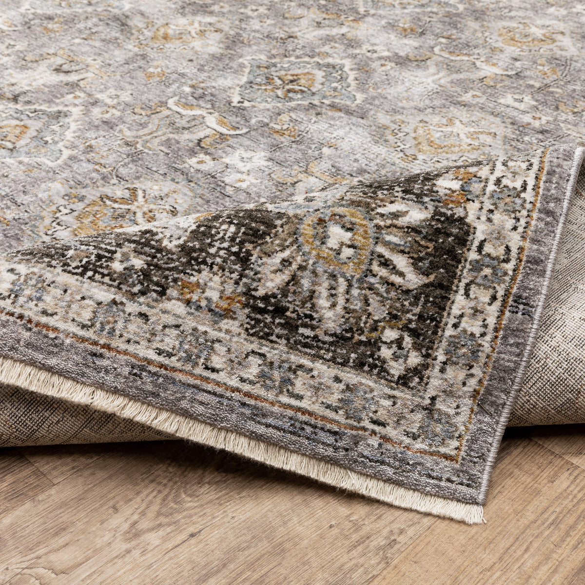 Grey and gold traditional patterned rug with dark ornate border