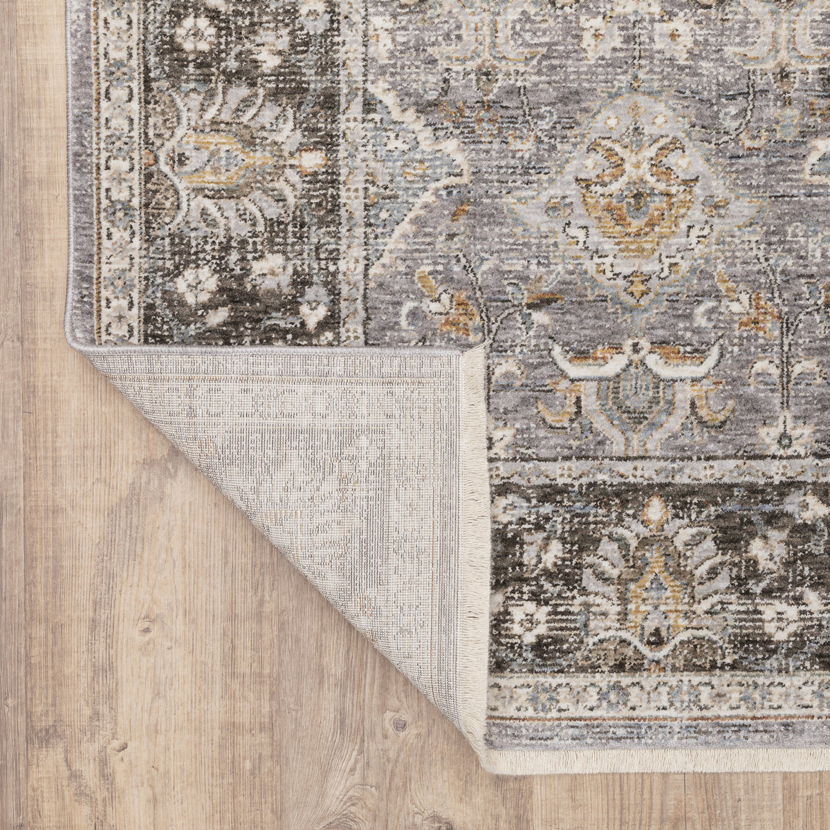 Grey and gold traditional patterned rug with dark ornate border