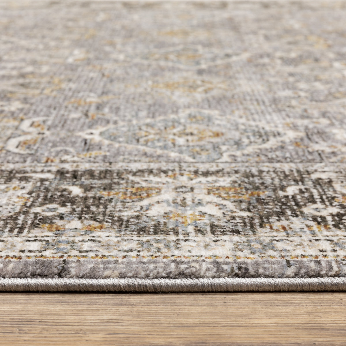 Grey and gold traditional patterned rug with dark ornate border