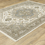 Traditional beige rug with blue and gold geometric medallion pattern and ornate borders