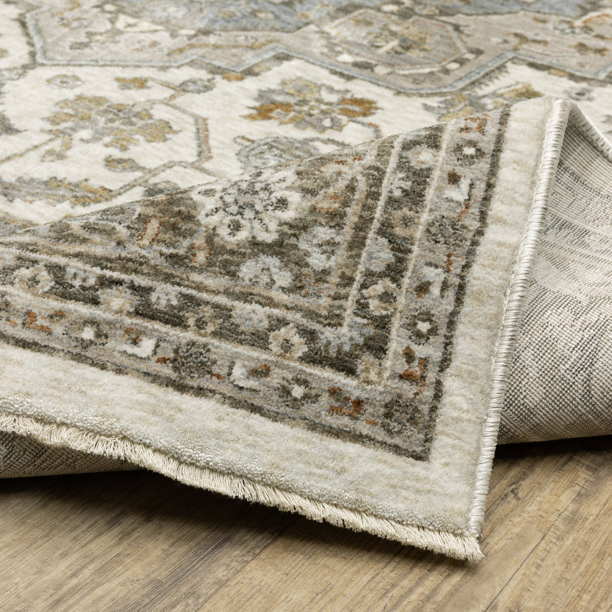 Traditional beige rug with blue and gold geometric medallion pattern and ornate borders