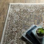 Traditional beige rug with blue and gold geometric medallion pattern and ornate borders