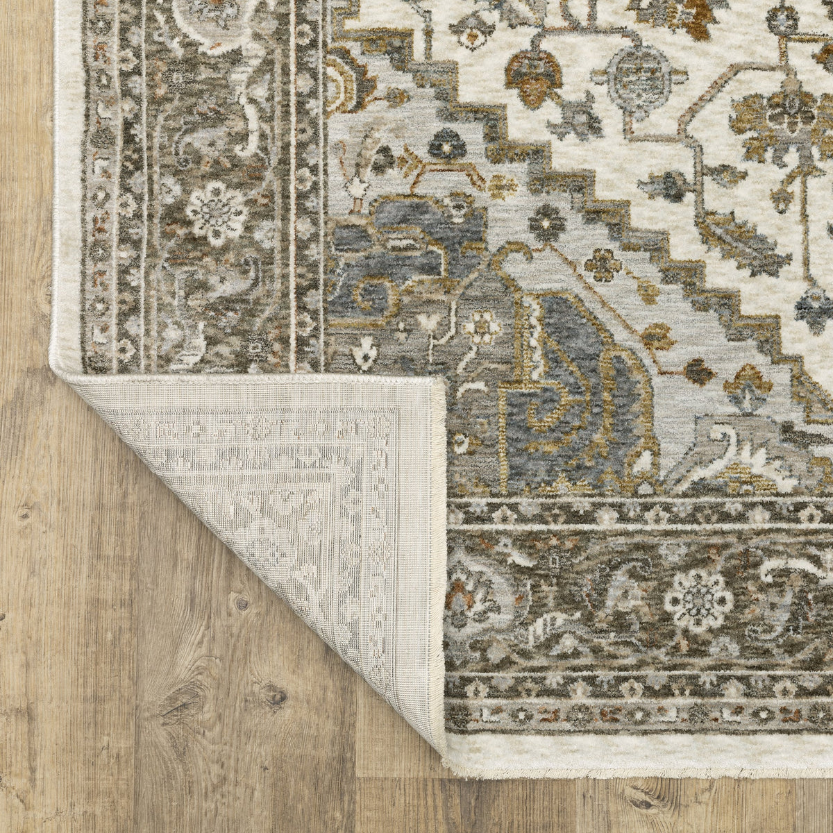 Traditional beige rug with blue and gold geometric medallion pattern and ornate borders