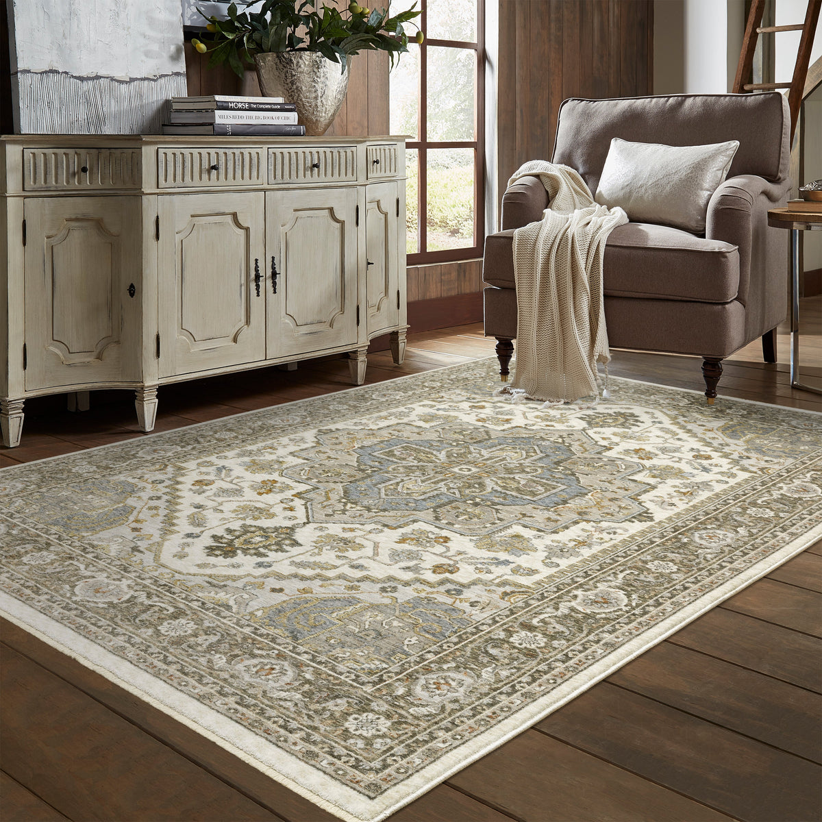 Traditional beige rug with blue and gold geometric medallion pattern and ornate borders