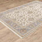 Cream and blue traditional floral area rug with ornate damask border design