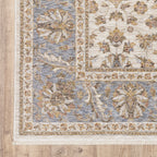 Cream and blue traditional floral area rug with ornate damask border design