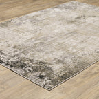 Modern living room with distressed gray and beige area rug under black coffee table
