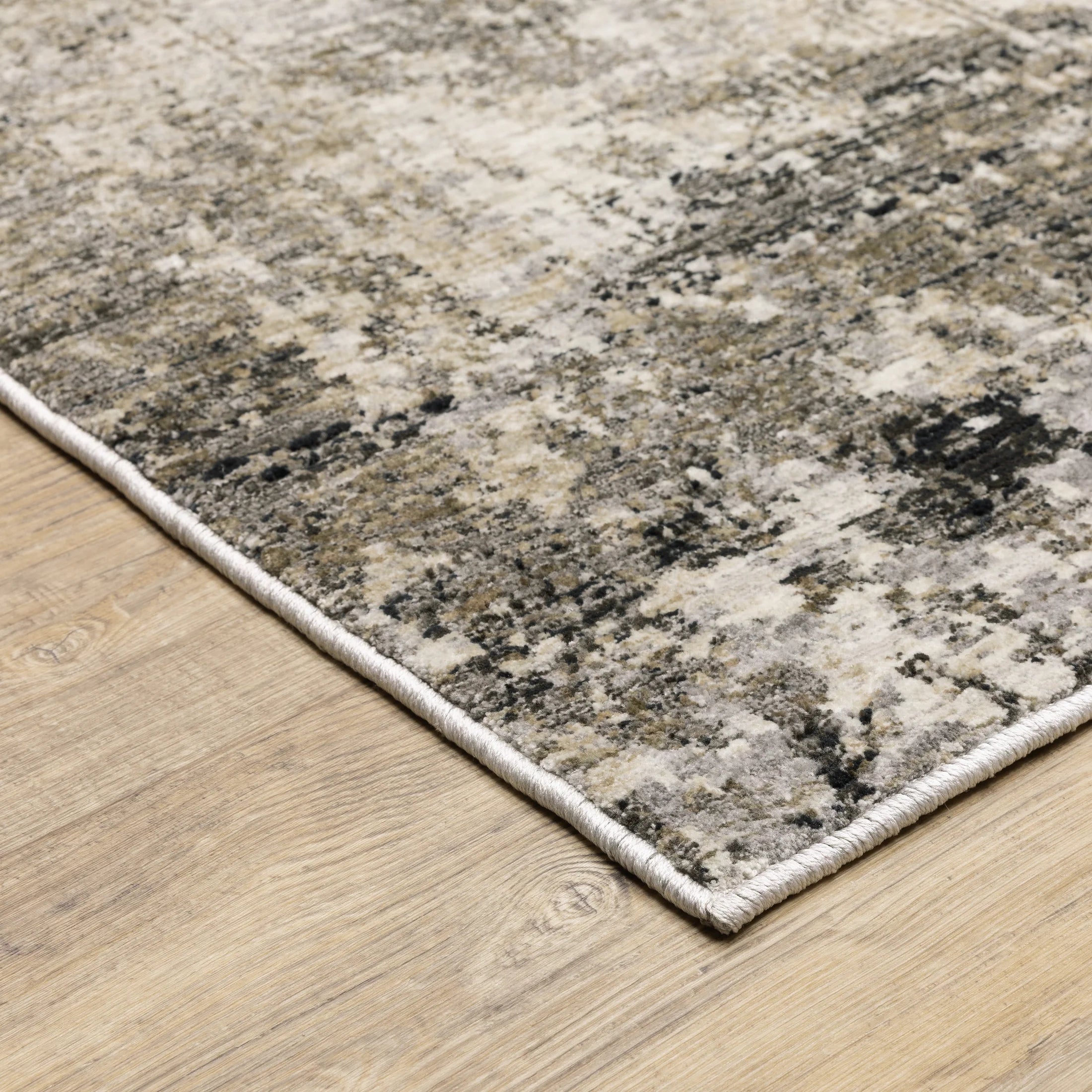 Modern living room with distressed gray and beige area rug under black coffee table
