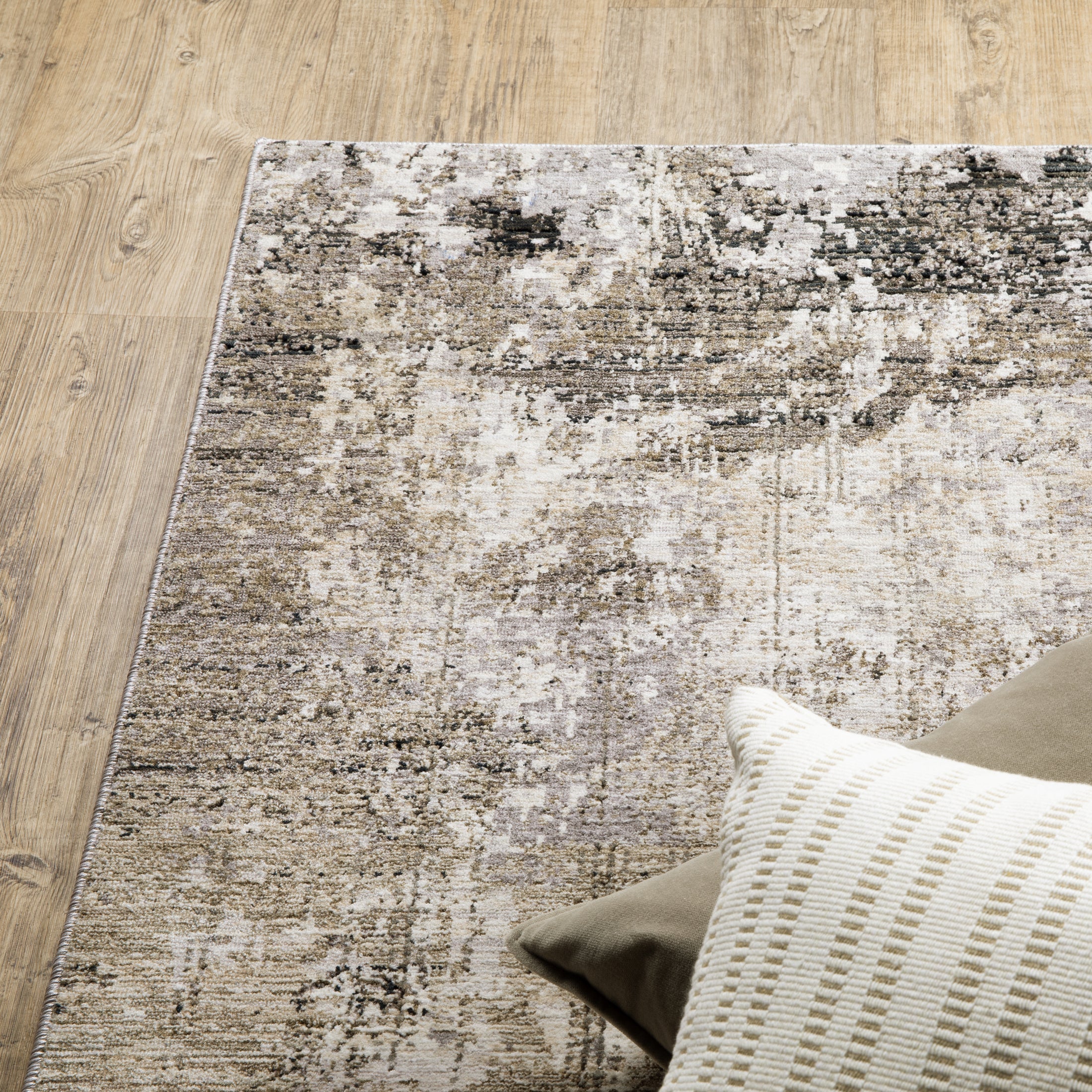 Modern living room with distressed gray and beige area rug under black coffee table