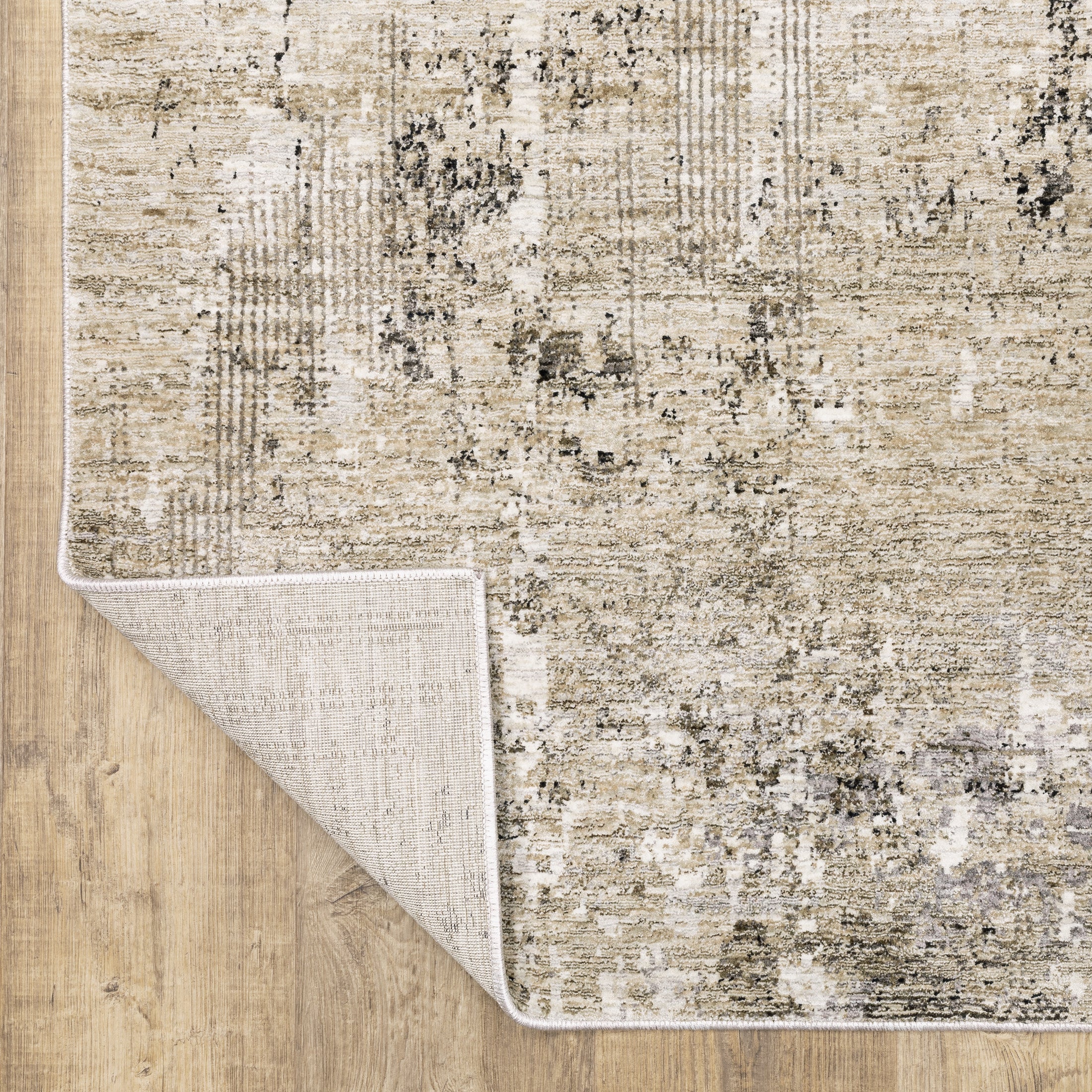 Modern living room with distressed gray and beige area rug under black coffee table