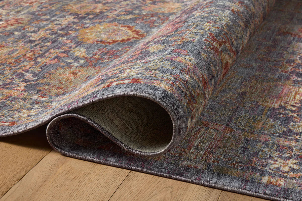 Vintage-style area rug with ornate floral medallions in blue, rust, and gold tones