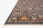 Vintage-style area rug with ornate floral medallions in blue, rust, and gold tones