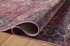 Burgundy distressed rug with ornate floral patterns in cream and rust tones