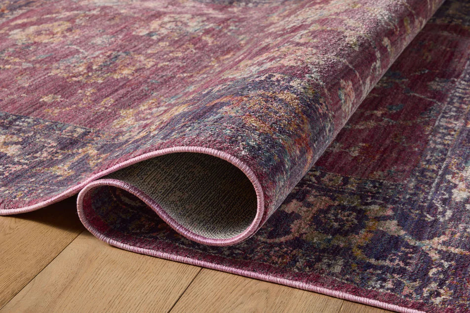 Burgundy distressed rug with ornate floral patterns in cream and rust tones