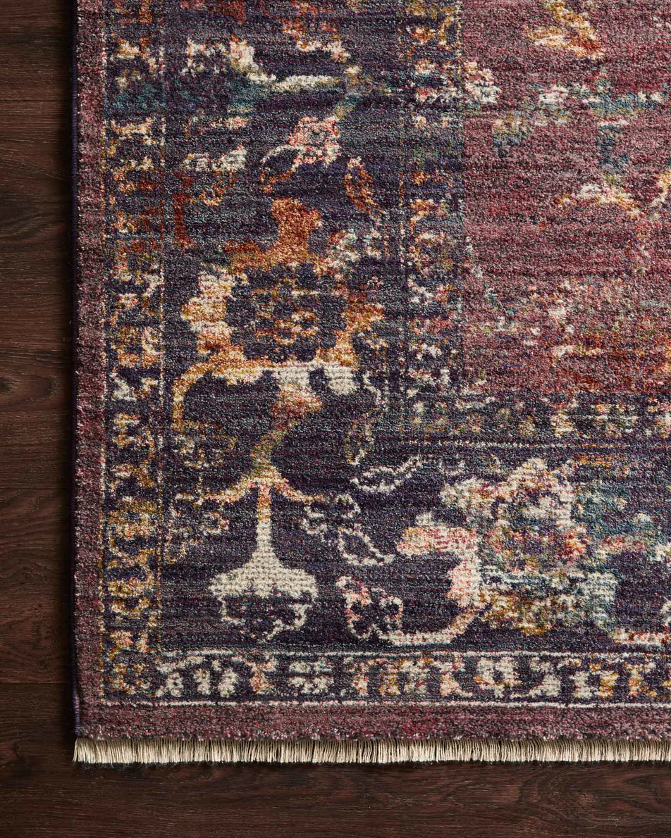 Burgundy distressed rug with ornate floral patterns in cream and rust tones