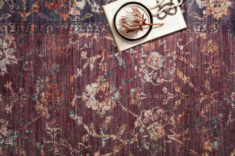 Burgundy distressed rug with ornate floral patterns in cream and rust tones