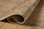 Vintage-inspired area rug with warm tan, blue, and purple tones in traditional pattern
