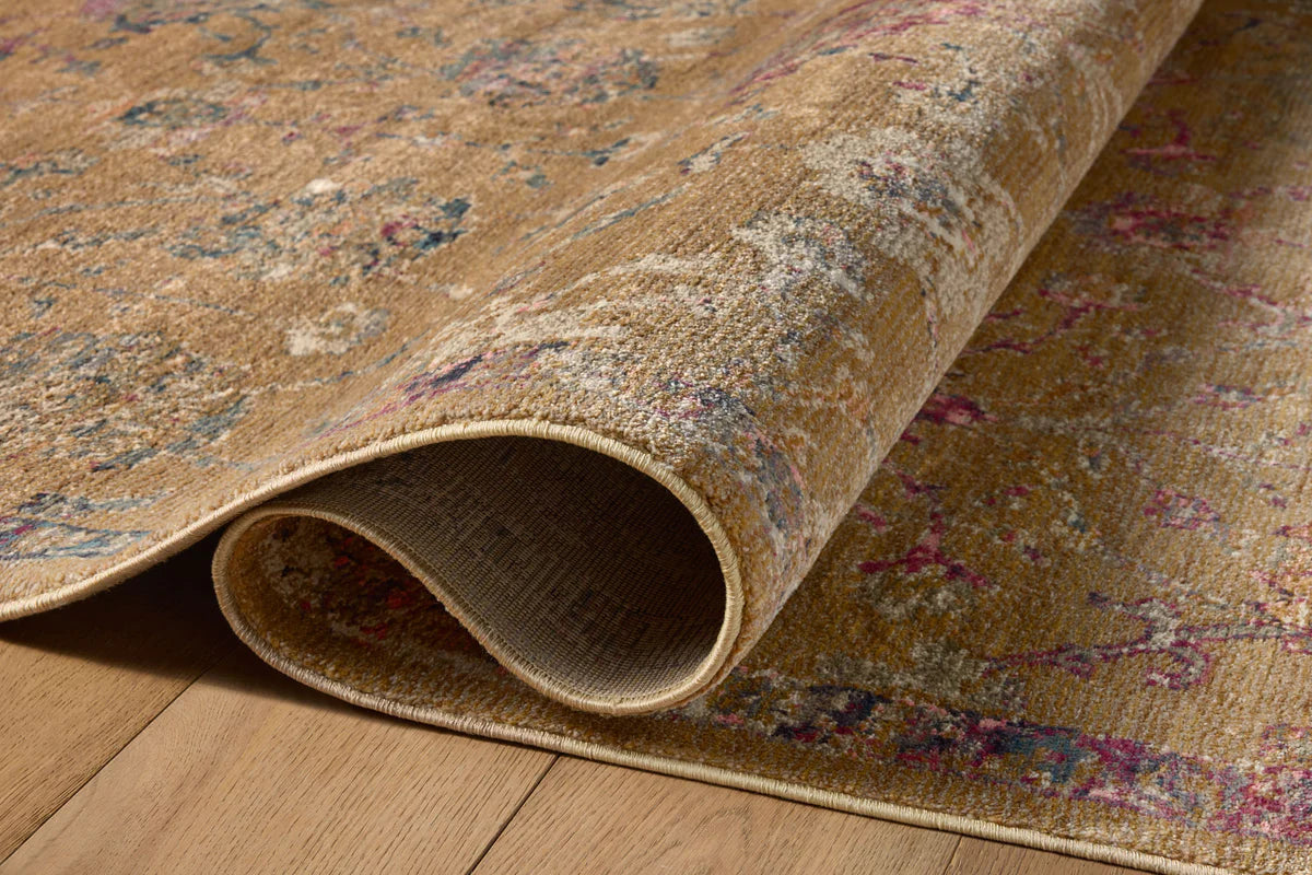 Vintage-inspired area rug with warm tan, blue, and purple tones in traditional pattern
