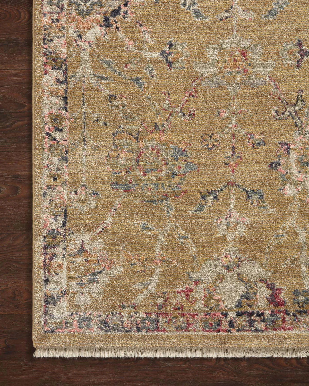 Vintage-inspired area rug with warm tan, blue, and purple tones in traditional pattern
