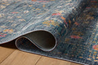 Blue vintage-style rug with floral motifs and ornate border design
