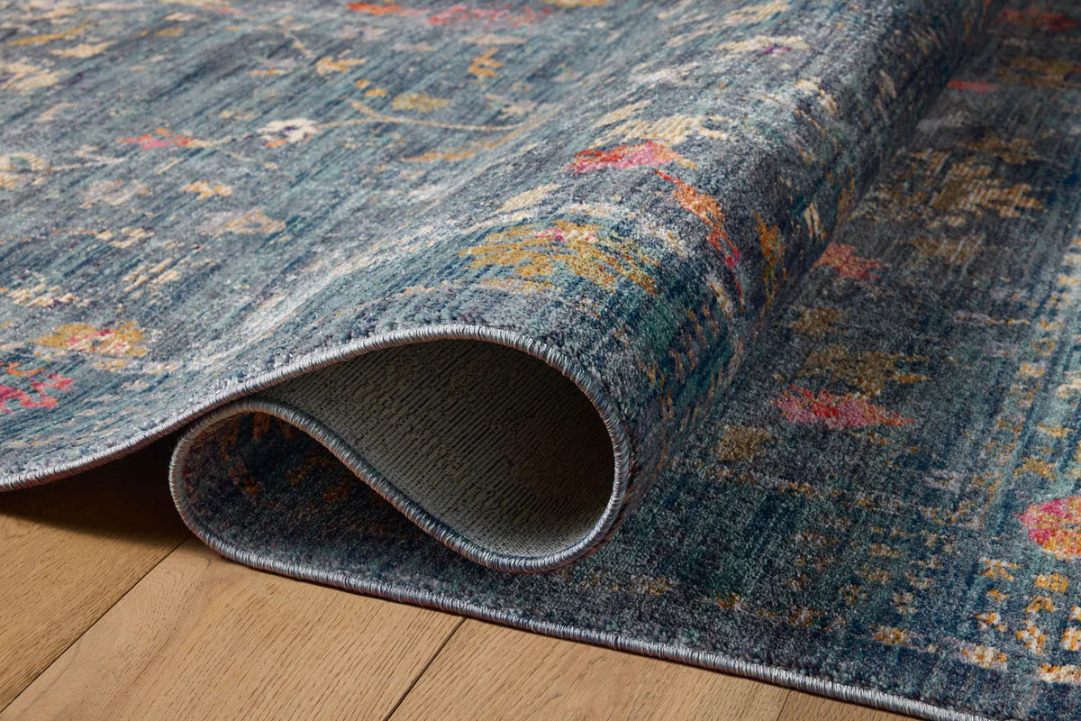 Blue vintage-style rug with floral motifs and ornate border design